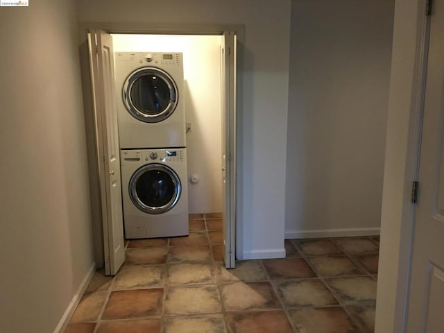 clothes washing area with stacked washer and dryer