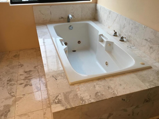 bathroom with tiled tub