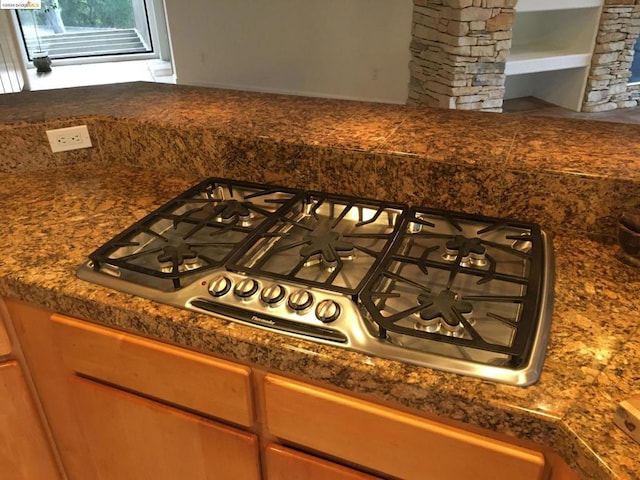 room details with stainless steel gas stovetop and decorative columns