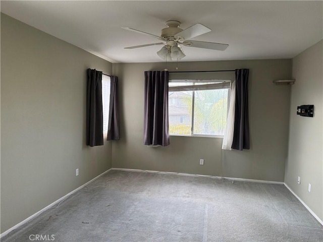 carpeted spare room with ceiling fan