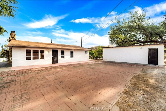 rear view of property featuring a patio