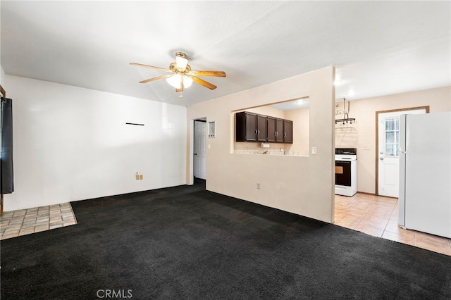 unfurnished living room featuring ceiling fan and light tile patterned floors