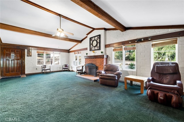 carpeted living room with ceiling fan, vaulted ceiling with beams, and a brick fireplace