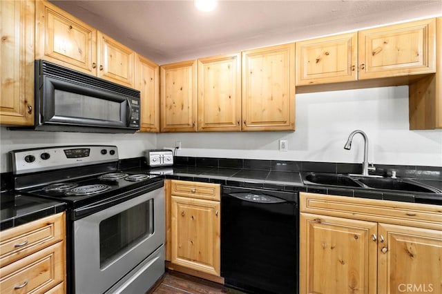 kitchen featuring black appliances, sink, light brown cabinetry, and dark hardwood / wood-style floors