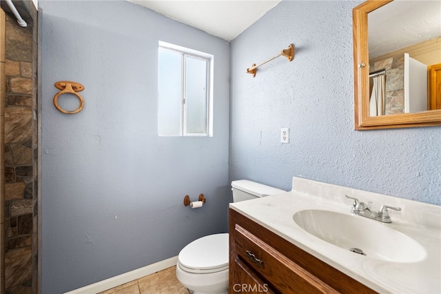 bathroom with tile patterned floors, vanity, and toilet