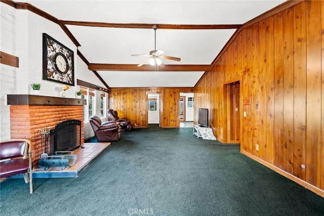 unfurnished living room with a brick fireplace, wooden walls, carpet flooring, and ceiling fan