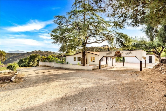 view of front facade with a mountain view, a carport, and a garage