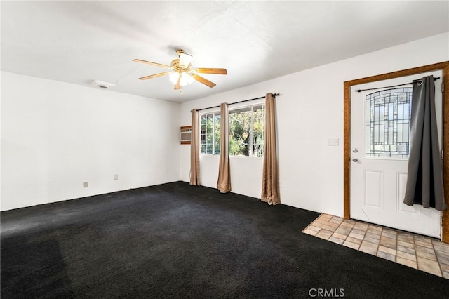 empty room featuring ceiling fan and light colored carpet