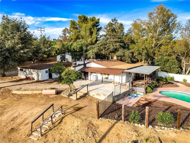 view of front of house featuring a fenced in pool