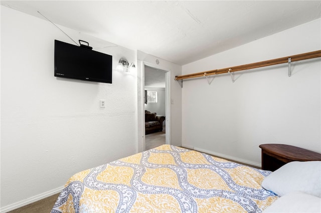 bedroom featuring vaulted ceiling and carpet floors