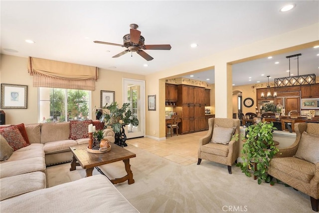 living room with light tile patterned floors and ceiling fan