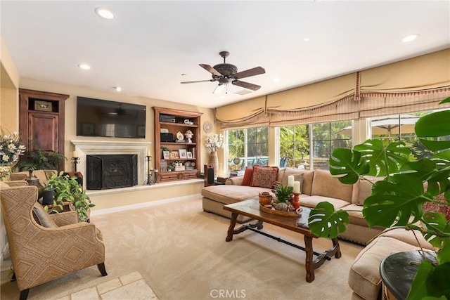 carpeted living room featuring ceiling fan