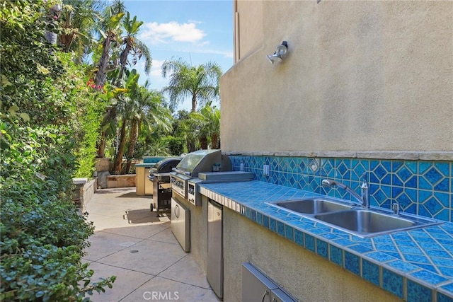 view of patio / terrace with a grill, area for grilling, and sink