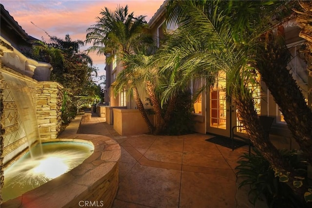 view of patio terrace at dusk