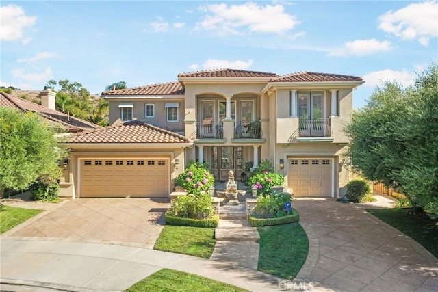 mediterranean / spanish home with a balcony and a garage