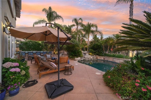 pool at dusk with a patio