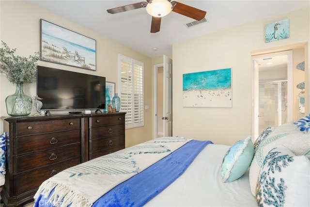 bedroom with ceiling fan and ensuite bath