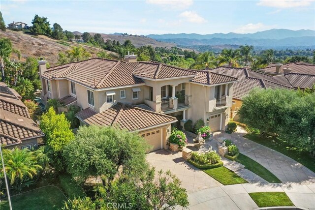 birds eye view of property with a mountain view