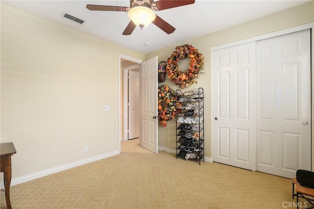 unfurnished bedroom with ceiling fan and a closet