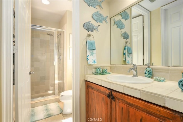 bathroom with an enclosed shower, vanity, and toilet