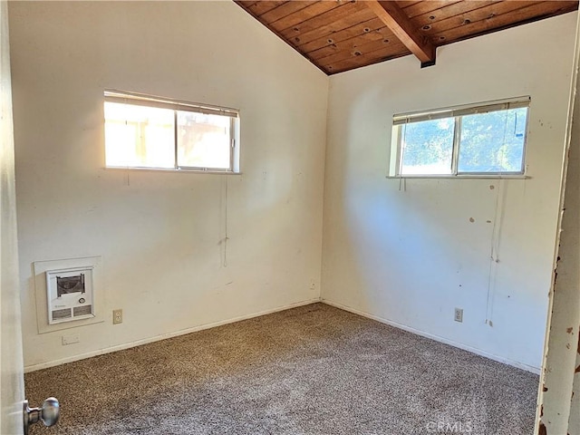 empty room featuring lofted ceiling with beams, wooden ceiling, and carpet floors