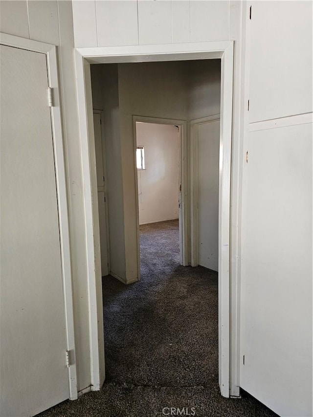 hallway with dark carpet