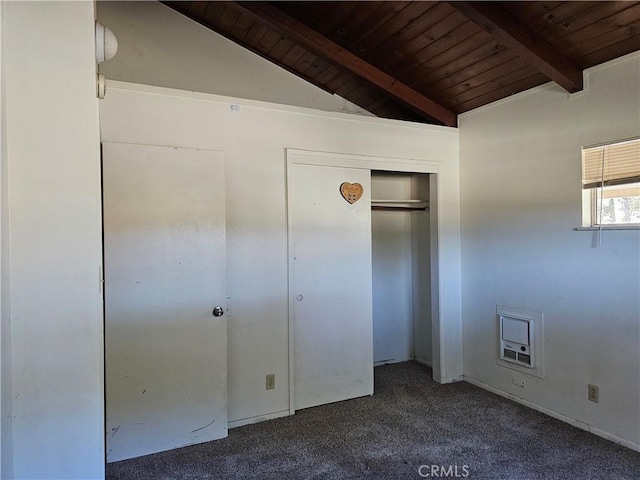 unfurnished bedroom featuring vaulted ceiling with beams, dark carpet, wood ceiling, and a closet