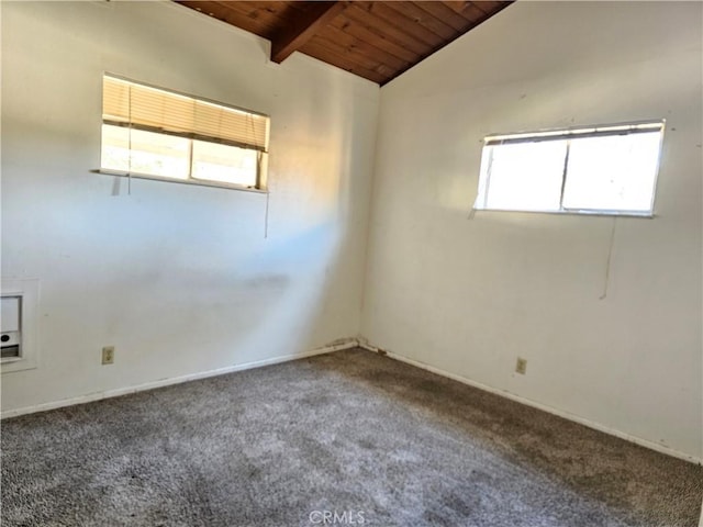 carpeted spare room with lofted ceiling with beams and wood ceiling