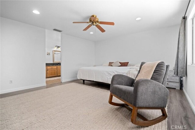 bedroom with ceiling fan, ensuite bathroom, and light hardwood / wood-style floors