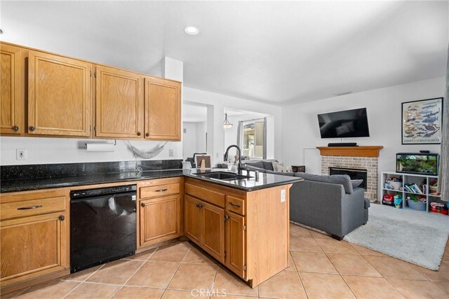 kitchen featuring a fireplace, light tile patterned floors, sink, and dishwasher