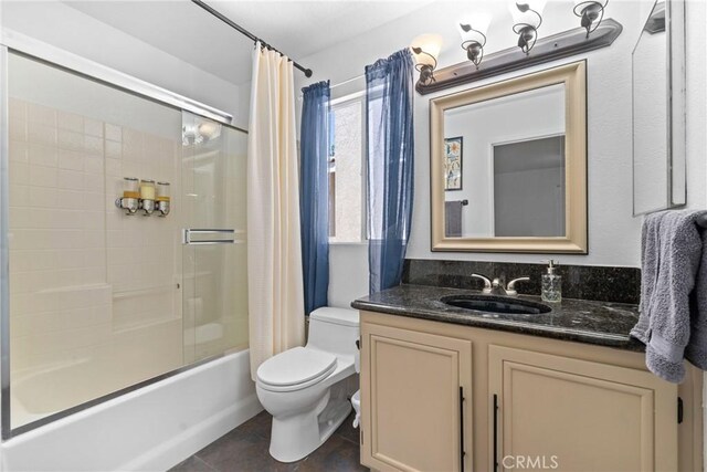 full bathroom featuring toilet, shower / tub combo with curtain, vanity, and tile patterned flooring