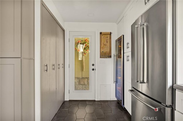 entryway with dark tile patterned floors