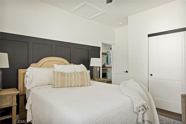 bedroom with ceiling fan and hardwood / wood-style flooring