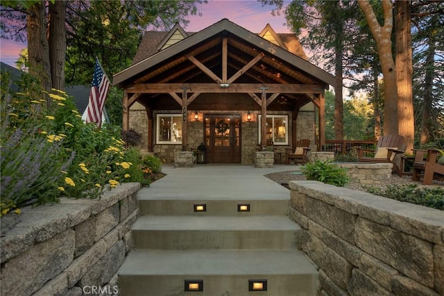 exterior entry at dusk featuring covered porch