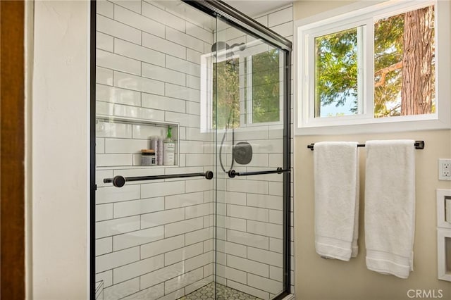 bathroom with a shower with door