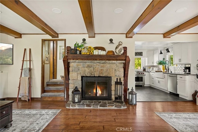 living room with beam ceiling, a fireplace, and dark hardwood / wood-style flooring