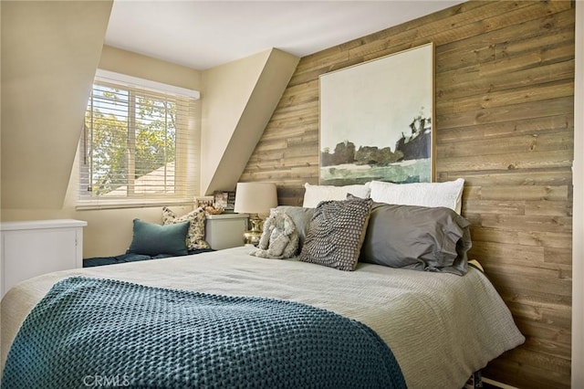 bedroom featuring wooden walls