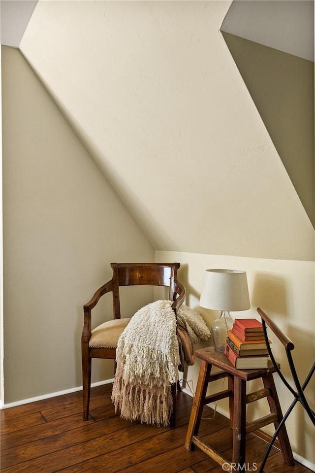 sitting room with dark hardwood / wood-style flooring and vaulted ceiling