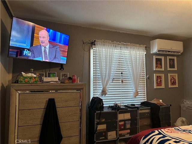 bedroom with multiple windows and a wall mounted AC