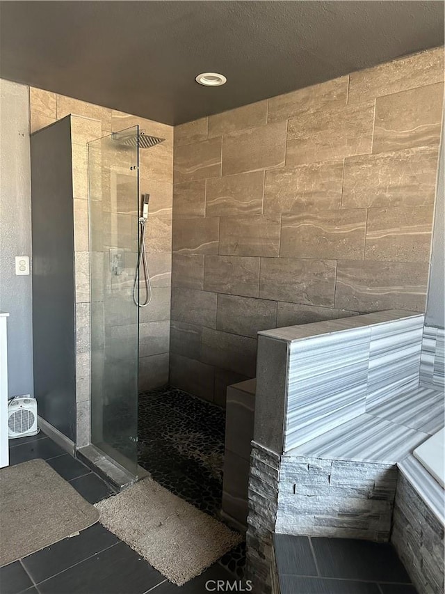 bathroom featuring tile patterned floors and tiled shower