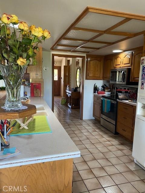 kitchen featuring sink, stainless steel appliances, and light tile patterned flooring