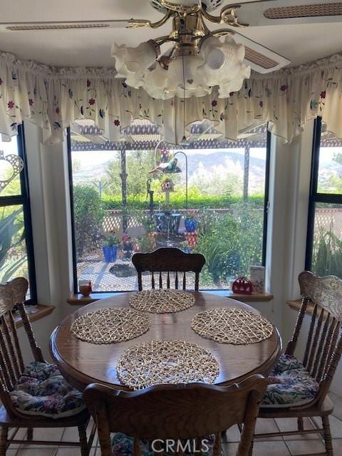 dining space with tile patterned flooring and ceiling fan