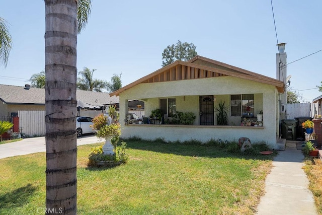 bungalow-style home with a front yard and covered porch