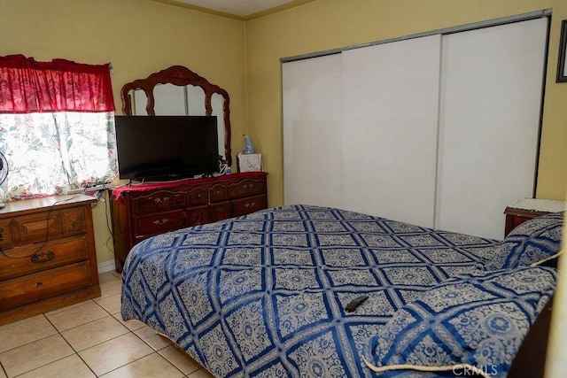 tiled bedroom featuring a closet