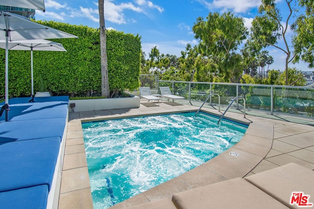 view of swimming pool with a patio area