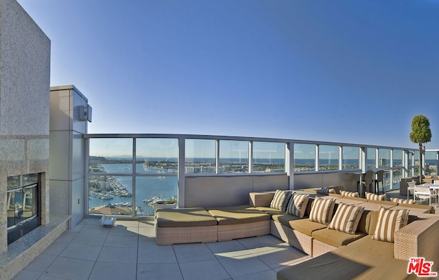 balcony with an outdoor hangout area and a water view