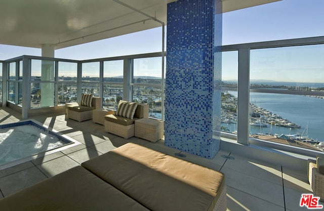 balcony featuring outdoor lounge area and a water view