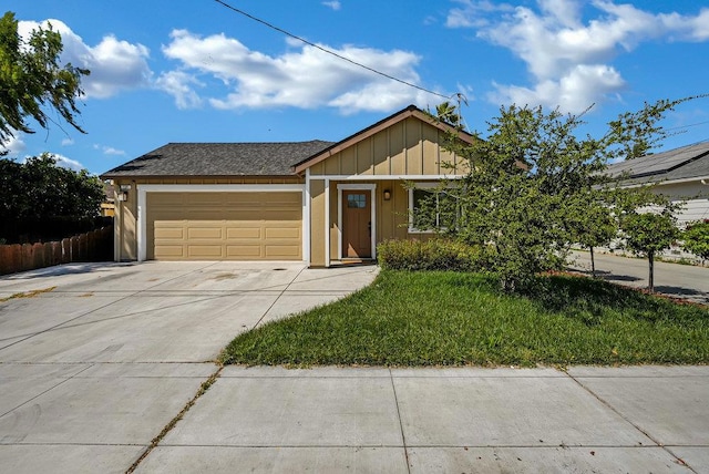 view of front of property featuring a garage and a front yard