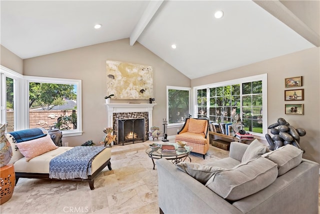 living room featuring vaulted ceiling with beams and a tile fireplace