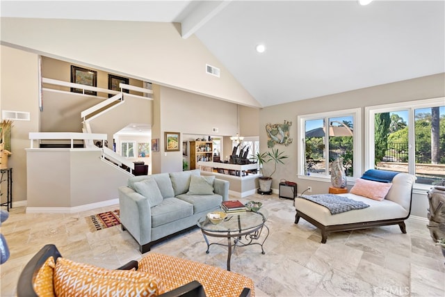 living room with beamed ceiling and high vaulted ceiling